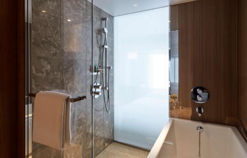 a shower with a glass door in a bathroom at Hilton Nagoya Hotel in Nagoya