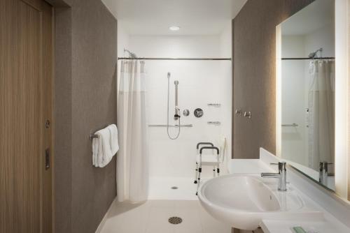 a white bathroom with a sink and a shower at Springhill Suites by Marriott Newburgh Evansville in Newburgh