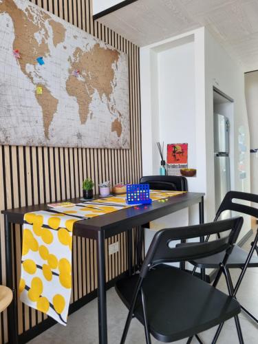 a table with chairs and a map on the wall at EndlessSummer in Focene
