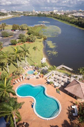 an aerial view of a resort with a swimming pool at Hilton Palm Beach PBI in West Palm Beach