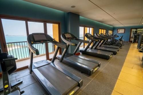 a row of treadmills in a gym with a view at DoubleTree by Hilton Resort & Spa Marjan Island in Ras al Khaimah