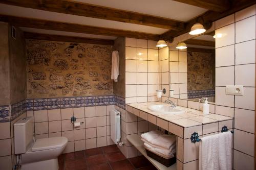 a bathroom with a sink and a toilet at Hotel Rural La Torre de Bisjueces in Bisjueces