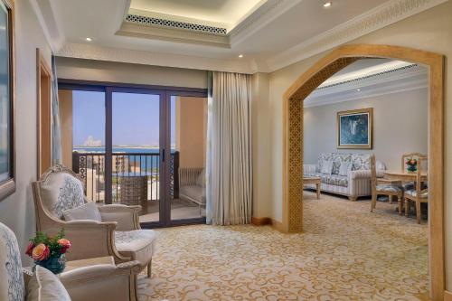 a large room with a living room with a balcony at DoubleTree by Hilton Resort & Spa Marjan Island in Ras al Khaimah