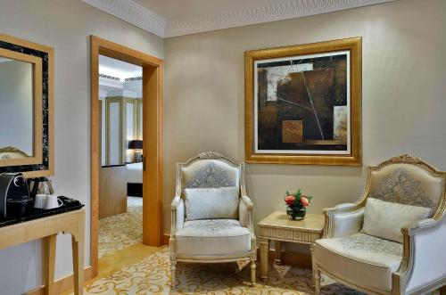 a living room with two chairs and a mirror at DoubleTree by Hilton Resort & Spa Marjan Island in Ras al Khaimah