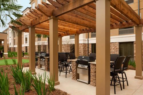 a pergola with tables and chairs on a patio at Homewood Suites by Hilton Shreveport Bossier City, LA in Bossier City