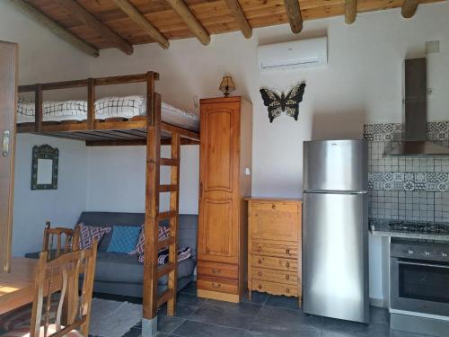a living room with a bunk bed and a kitchen at LUX CASITA Almendral in Lanjarón