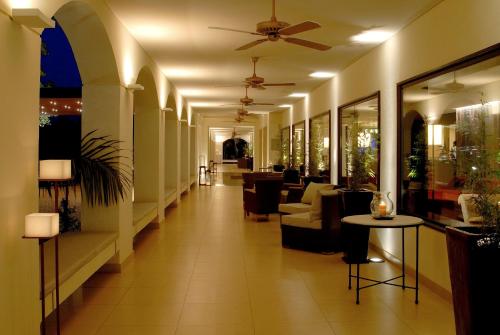 a hallway with chairs and tables in a lobby at Panoramic Grand - Iguazú in Puerto Iguazú