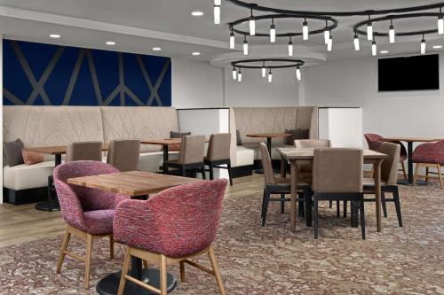 a dining room with tables and chairs and a chandelier at Hilton Garden Inn Bethesda Downtown in Bethesda