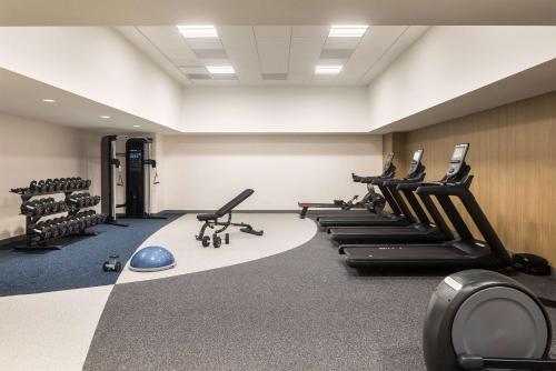 a gym with a row of treadmills and machines at Hilton Garden Inn Bethesda Downtown in Bethesda