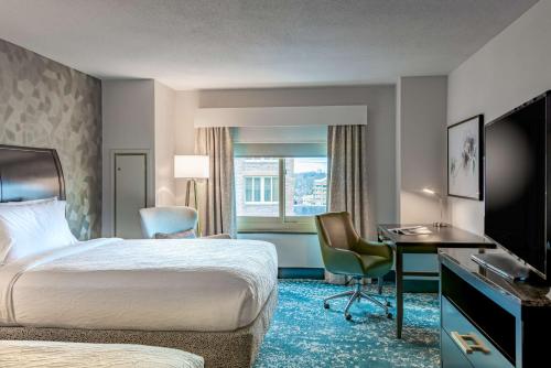 a hotel room with a bed and a desk at Hilton Garden Inn Bethesda Downtown in Bethesda
