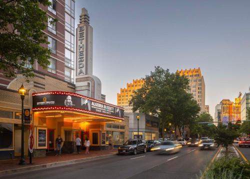 a city street with cars driving down a street with buildings at Hilton Garden Inn Bethesda Downtown in Bethesda