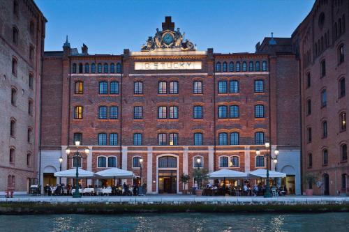 a large brick building with a clock on top of it at Hilton Molino Stucky Venice in Venice