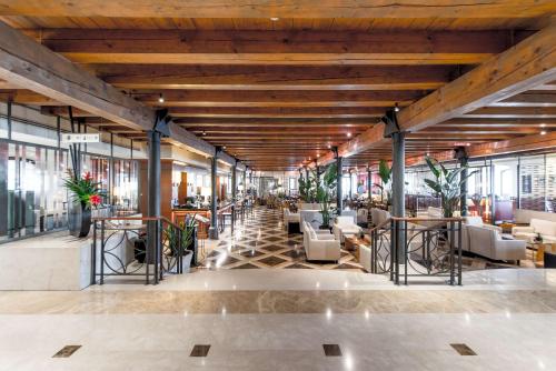 a lobby of a building with tables and chairs at Hilton Molino Stucky Venice in Venice