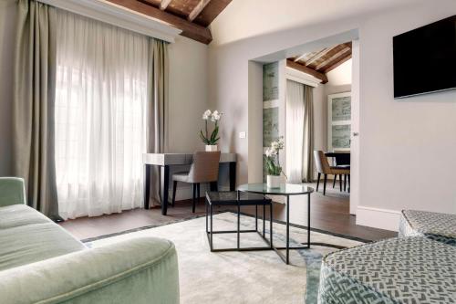 a living room with a couch and a table at Hilton Molino Stucky Venice in Venice