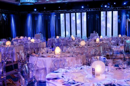 a large room filled with tables with white table settings at Hilton Molino Stucky Venice in Venice