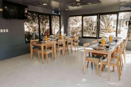 a dining room with a long table and chairs at Howard Johnson Hotel Yerba Buena in Yerba Buena