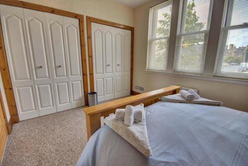 a bedroom with a bed with towels on it at 1 Argyle Place, Dornoch in Dornoch
