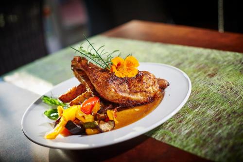 a plate of food with meat and vegetables on a table at Hotel Brunnenhof in Bayerisch Eisenstein