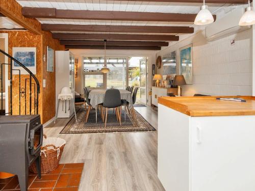 a kitchen and dining room with a table and chairs at 6 person holiday home in Ebeltoft in Ebeltoft