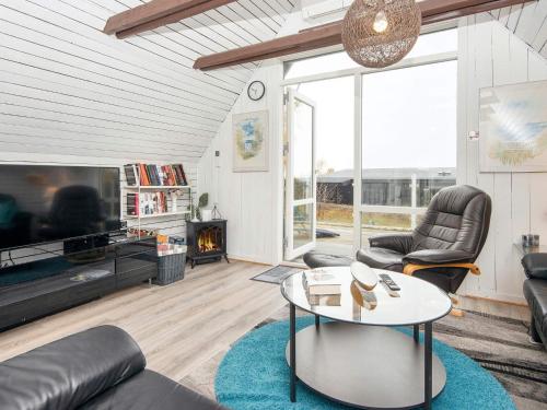 a living room with a couch and a table at 6 person holiday home in Ebeltoft in Ebeltoft