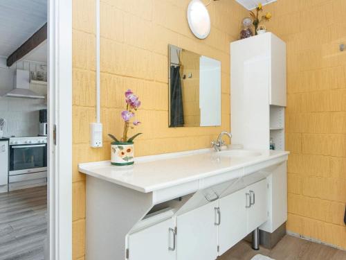 a bathroom with a white sink and a mirror at 6 person holiday home in Ebeltoft in Ebeltoft
