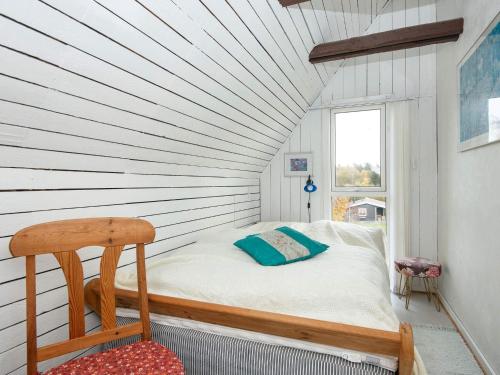 a small bed in a room with a window at 6 person holiday home in Ebeltoft in Ebeltoft