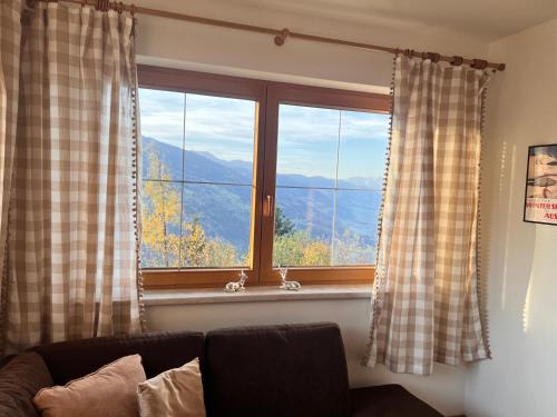 a living room with a window with a mountain view at New Chalet Platzhirsch Panorama Blick Sauna Rohrberg Maximilian in Rohrberg