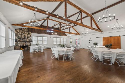 a banquet hall with white tables and white chairs at Club Hotel in Idaho Springs
