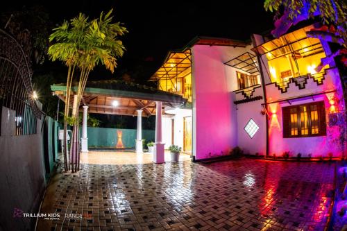 a house with pink lights on the side of it at Casa Suite Seenigama - Hikkaduwa in Hikkaduwa
