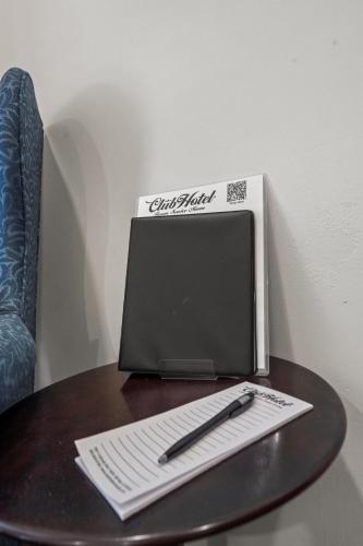 a desk with a box and a pen and a notebook at Club Hotel in Idaho Springs