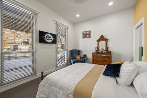 a bedroom with a bed and a dresser and a window at Club Hotel in Idaho Springs
