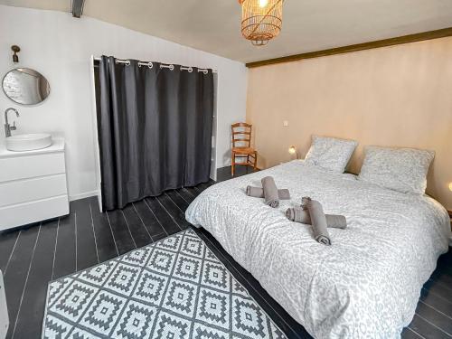 a bedroom with a bed with two teddy bears on it at Maison Atypique accès direct Paris, Cuisine design in Bois-Colombes