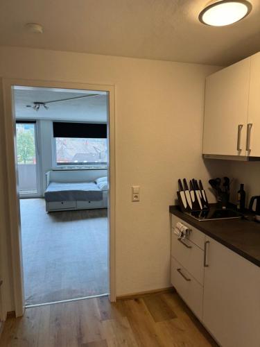 a room with a kitchen and a bedroom with a bed at Domview Apartment in St. Blasien