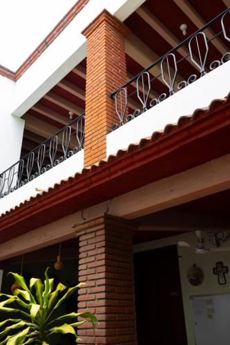 a balcony on top of a house with a building at Hotel Magda in Oaxaca City