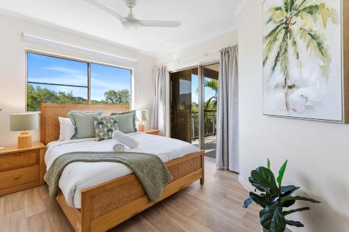 a bedroom with a bed and a large window at La Palma Cairns- Resort 9 Pools & Gym in Westcourt