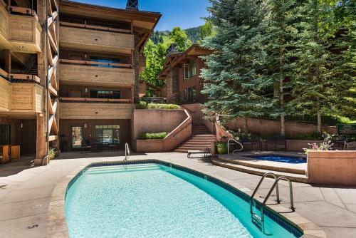 a swimming pool in front of a building at Aspen Condo W Pool, Hot Tub & 2 Blocks To Gondola - Fh4 in Aspen