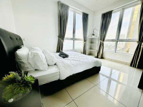 a bedroom with a bed with white sheets and pillows at 10pax 3-Bedroom l Seaview l Georgetown l Gleneagles l Mansion One in George Town