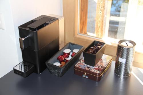 a small refrigerator sitting on a table with a box of chocolates at La Grange de Soulalex in Orsières