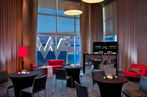 a restaurant with tables and chairs and a large window at W Austin in Austin