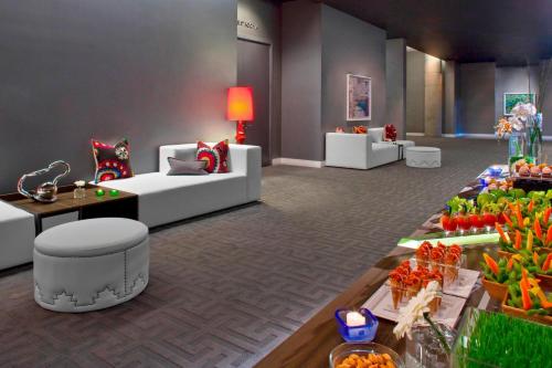 a living room with a table with food on it at W Austin in Austin
