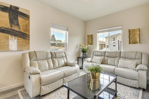 a living room with two couches and a table at Chowchilla Home with Private Patio! in Chowchilla