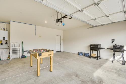 a room with a table and a board in it at Chowchilla Home with Private Patio! in Chowchilla