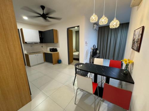 a dining room and kitchen with a table and chairs at The Podium, Kuching in Kuching