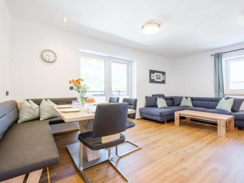 a living room with a couch and a table at Roßbrand-Blick in Untertauern