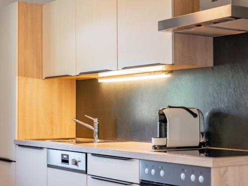 a kitchen with a sink and a toaster on a counter at Roßbrand-Blick in Untertauern