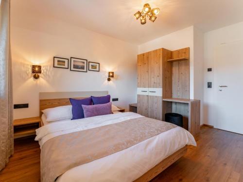 a bedroom with a large bed with blue pillows at Roßbrand-Blick in Untertauern