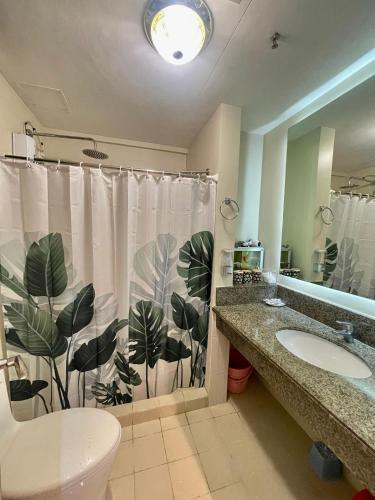 a bathroom with a shower curtain and a sink at Mirea Residences Pasig- Two Bedroom Condo Unit with Balcony 70sqm in Manila