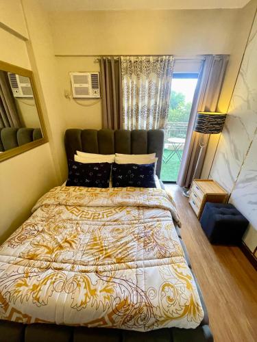 a bedroom with a large bed with a large window at Mirea Residences Pasig- Two Bedroom Condo Unit with Balcony 70sqm in Manila