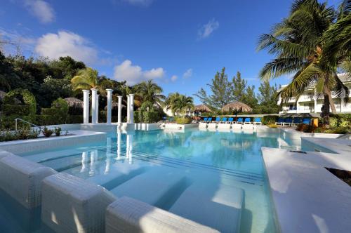 a swimming pool with a fountain in a resort at Grand Palladium Jamaica Resort & Spa All Inclusive in Lucea