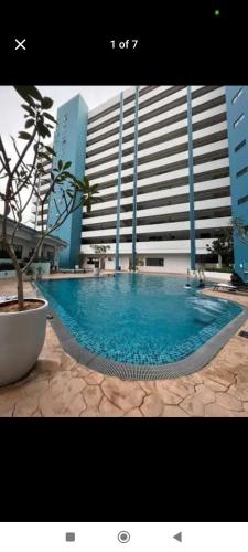 a large swimming pool in front of a building at Mutiara Melaka Beach Resort in Kampong Pantai Dusun